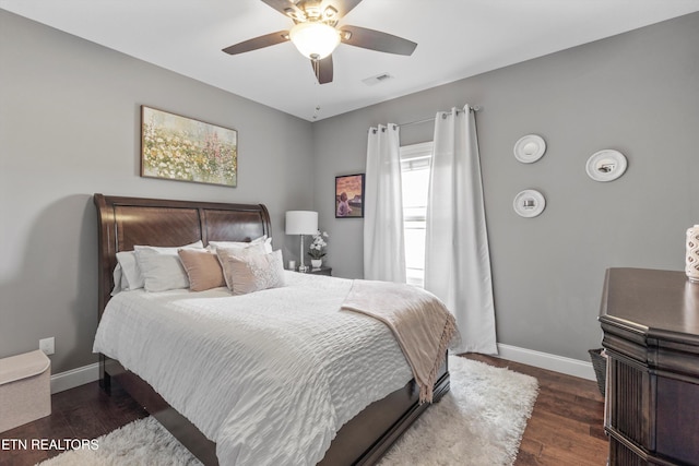 bedroom with ceiling fan and dark hardwood / wood-style flooring