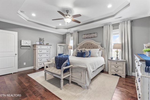 bedroom featuring a tray ceiling, ceiling fan, dark hardwood / wood-style flooring, and crown molding