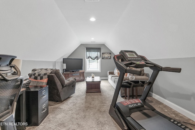 workout room featuring vaulted ceiling and carpet