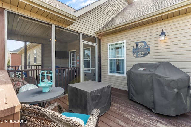 wooden deck featuring a grill