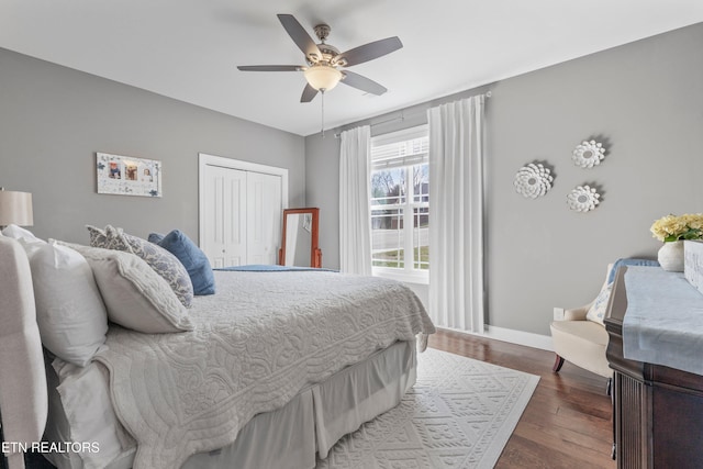 bedroom with hardwood / wood-style flooring, ceiling fan, and a closet