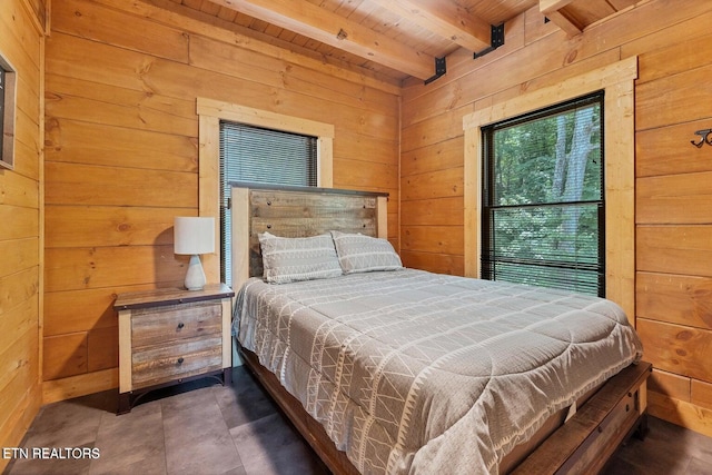 bedroom with beamed ceiling, wooden ceiling, and wooden walls