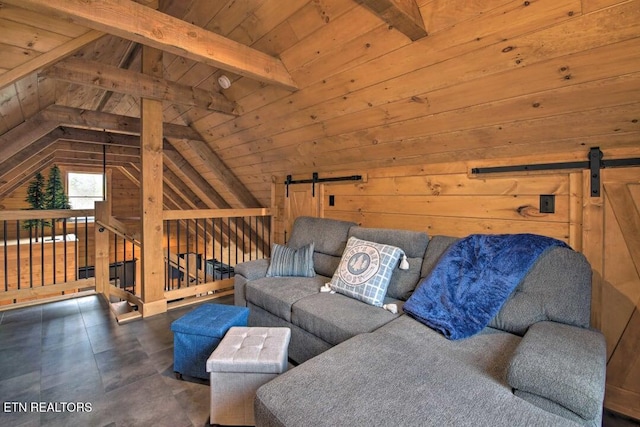 living room featuring a barn door, lofted ceiling with beams, and wood walls