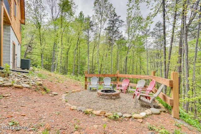 view of yard with central AC unit and a fire pit