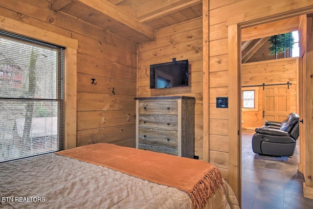 bedroom featuring beamed ceiling, multiple windows, and wood walls