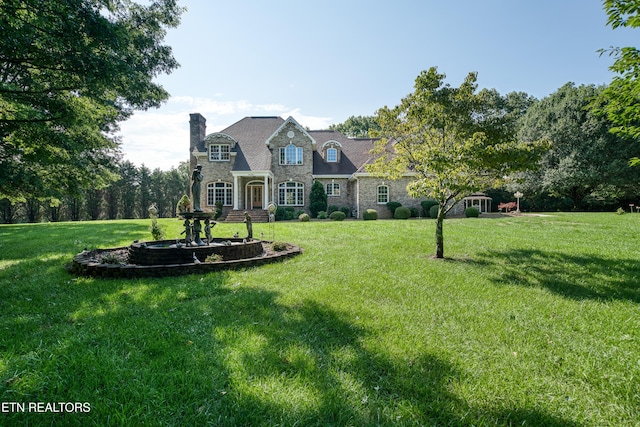 french country style house featuring a front yard