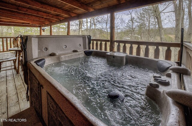 wooden deck with a hot tub