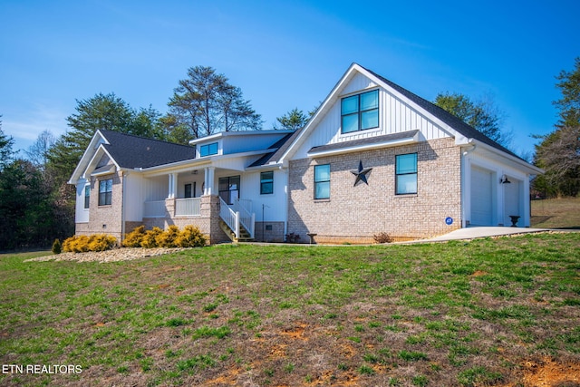 view of front of house featuring a garage, covered porch, and a front lawn