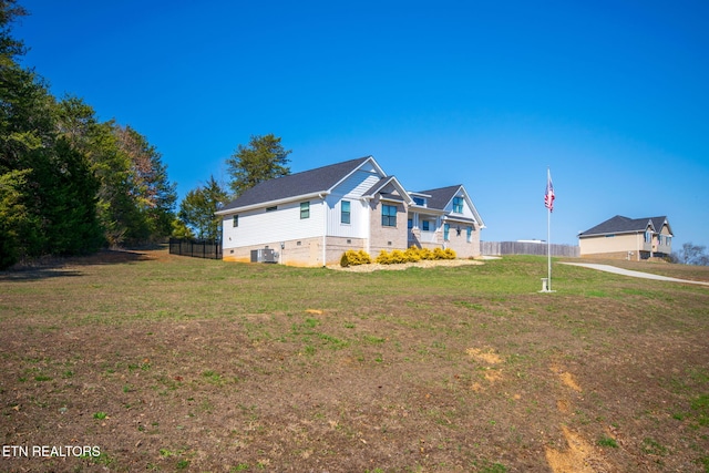 view of front of property featuring central air condition unit and a front yard