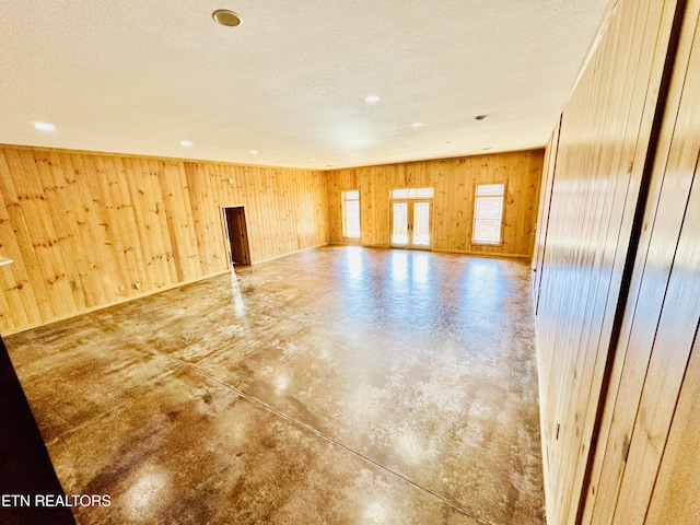 617 Cheyenne Dr, Jamestown, TN 38556 - empty room featuring concrete floors, wood walls, a textured ceiling, and recessed lighting