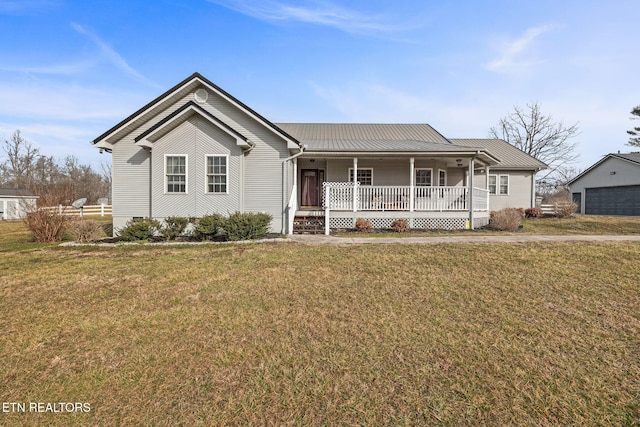 view of front of home featuring metal roof, a porch, and a front yard