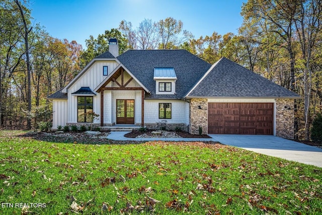 view of front of property with a garage and a front lawn