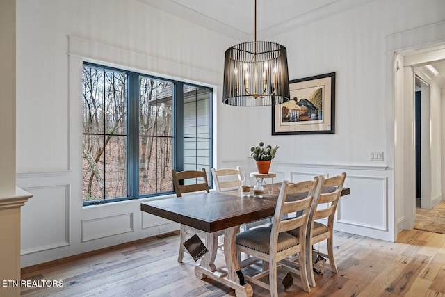 dining room with a notable chandelier and light wood-type flooring