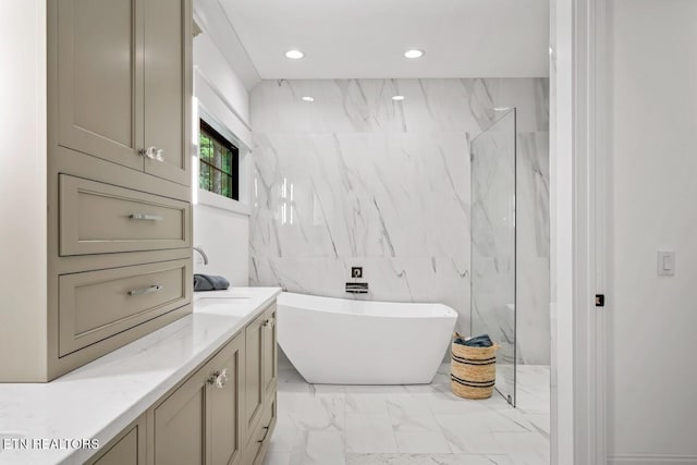 bathroom featuring vanity, shower with separate bathtub, and tile walls