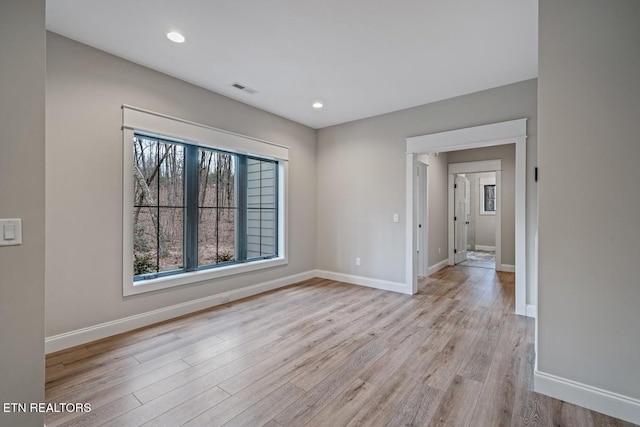 spare room featuring light wood-type flooring