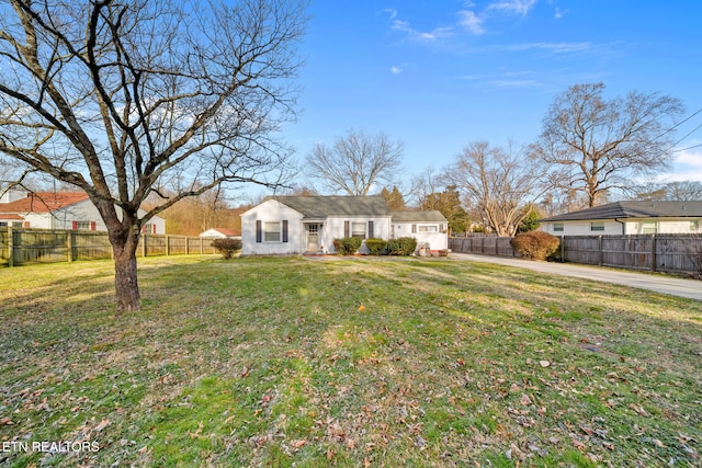 view of front of house with a front lawn and fence private yard