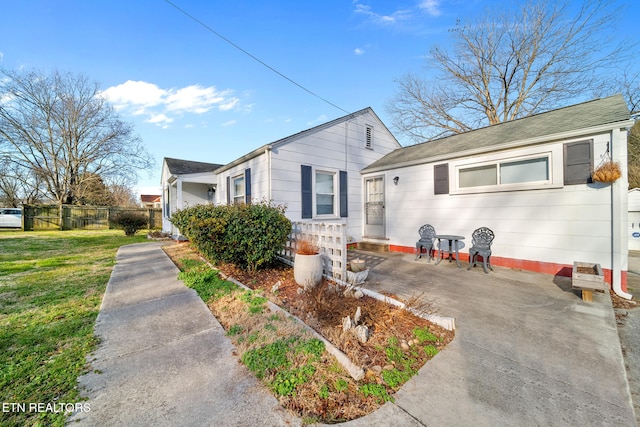 view of side of property with a yard and fence