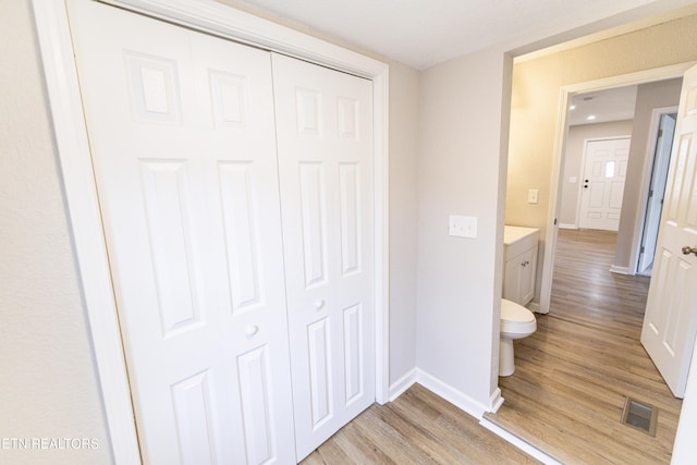 bathroom with vanity, hardwood / wood-style floors, and toilet