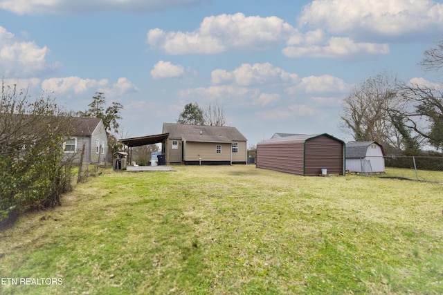 view of yard with a carport and a storage shed