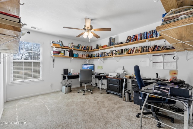 carpeted office featuring ceiling fan, visible vents, and baseboards