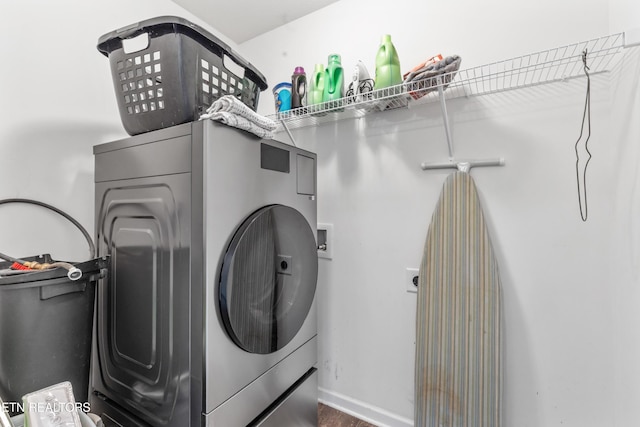 laundry area with laundry area, hookup for a washing machine, and baseboards