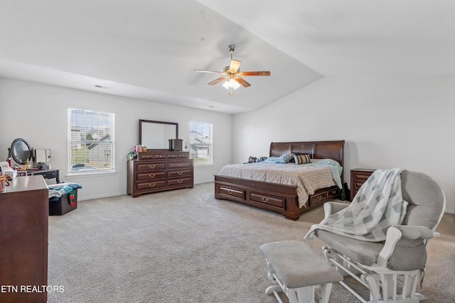 bedroom featuring a ceiling fan, lofted ceiling, light colored carpet, and baseboards