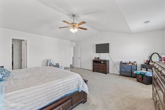 bedroom with light colored carpet, visible vents, vaulted ceiling, and ceiling fan