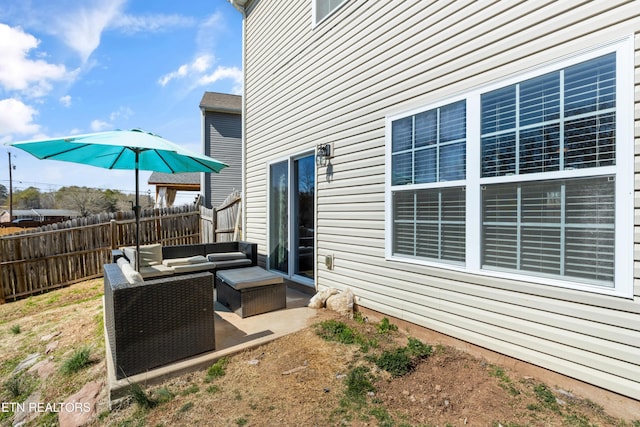 view of patio featuring fence and an outdoor hangout area