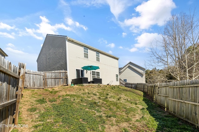 back of house with a yard, central AC unit, and a fenced backyard