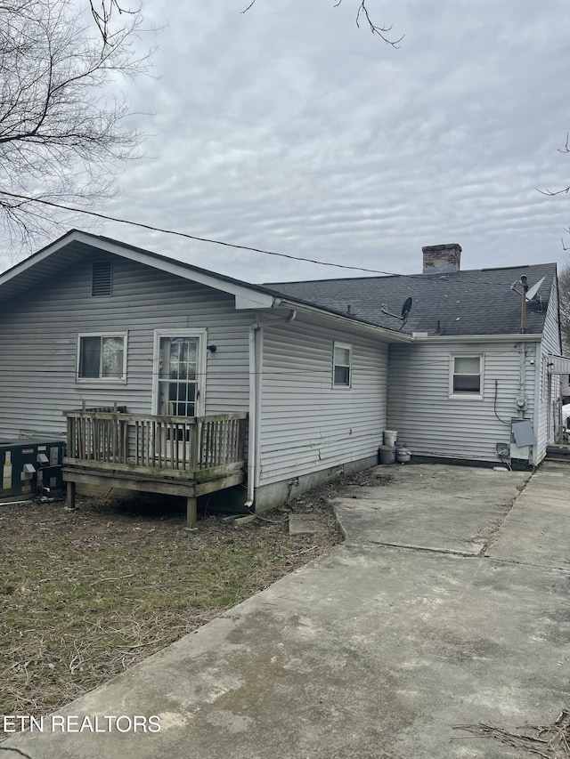 rear view of house featuring a patio area and a deck