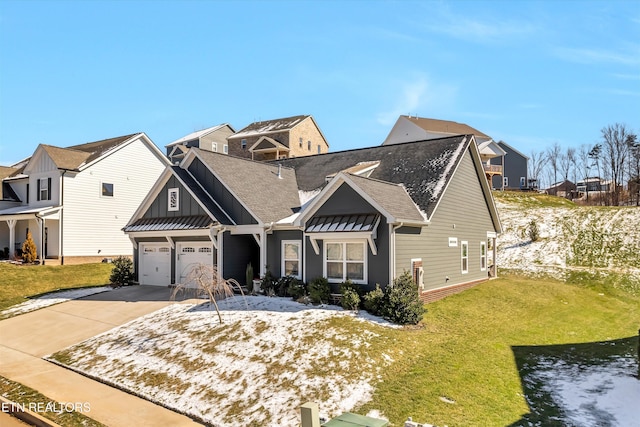 view of front of house with a standing seam roof, driveway, a front lawn, and board and batten siding