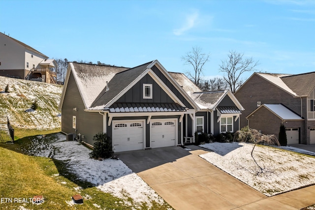 view of front of house with board and batten siding and concrete driveway