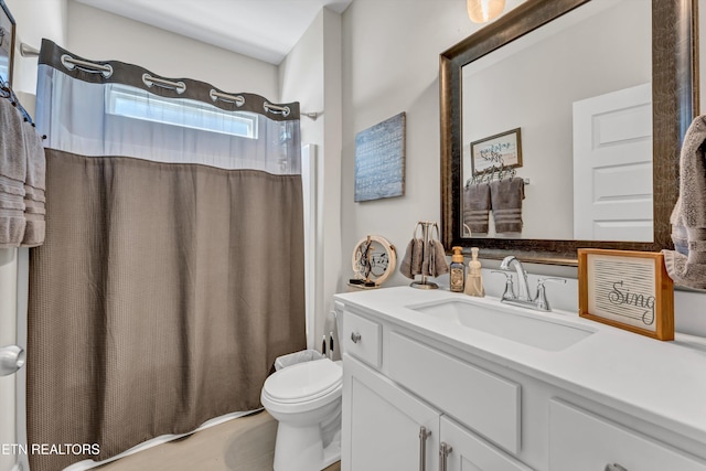 full bathroom with curtained shower, vanity, and toilet