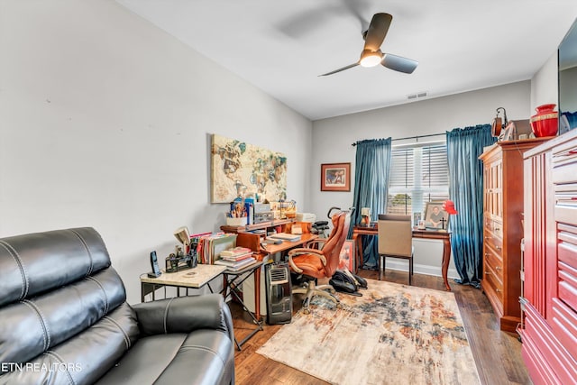 office featuring dark wood-style floors, visible vents, and ceiling fan