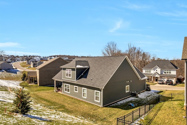 view of property exterior featuring a lawn, fence, a residential view, and central air condition unit