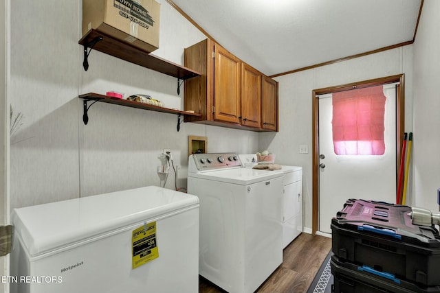 laundry area with dark wood-type flooring, cabinets, and washing machine and dryer