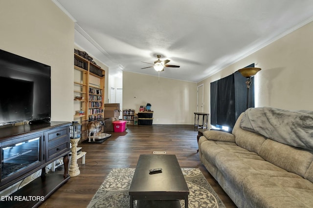 living room featuring dark hardwood / wood-style flooring, ornamental molding, and ceiling fan