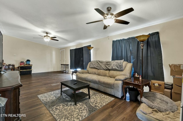 living room featuring ornamental molding, dark wood-type flooring, and ceiling fan
