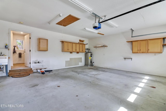 garage featuring water heater and a garage door opener