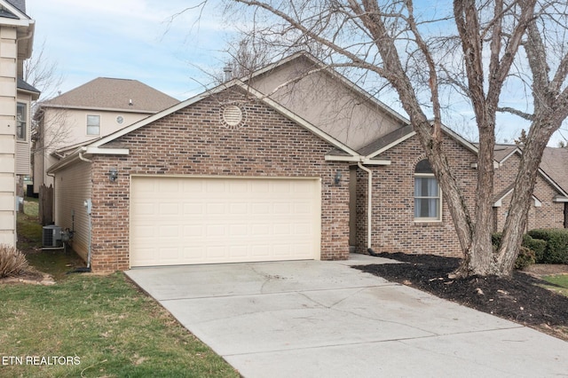 front facade featuring a garage and cooling unit