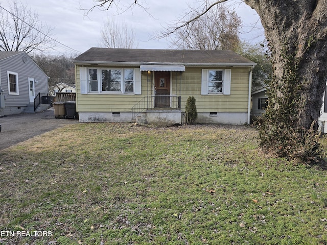 bungalow featuring crawl space, driveway, and a front lawn