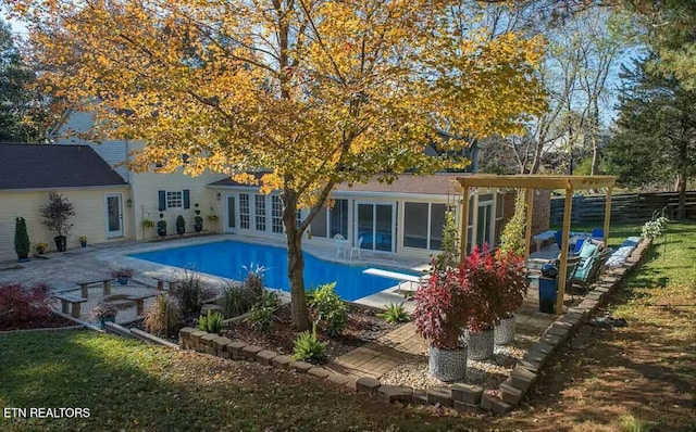 view of pool featuring a patio, french doors, and a diving board