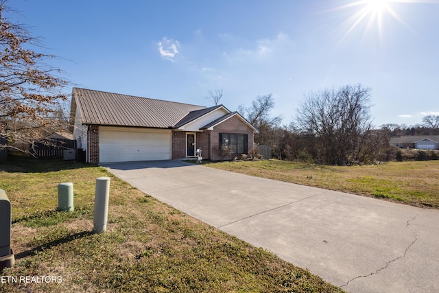 view of front of home with brick siding, an attached garage, concrete driveway, and a front lawn