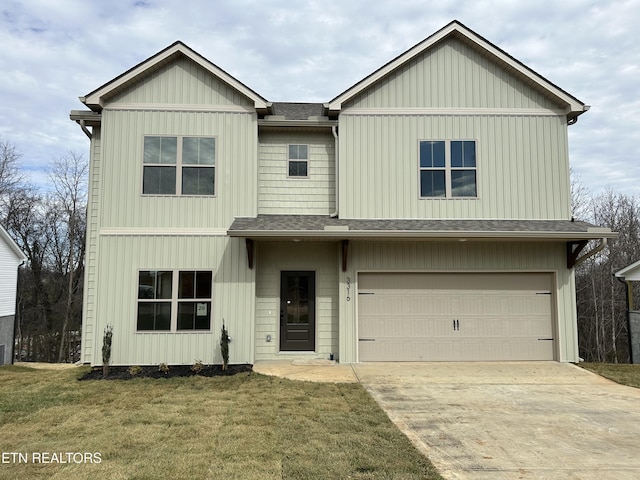 view of front of house with a garage and a front lawn