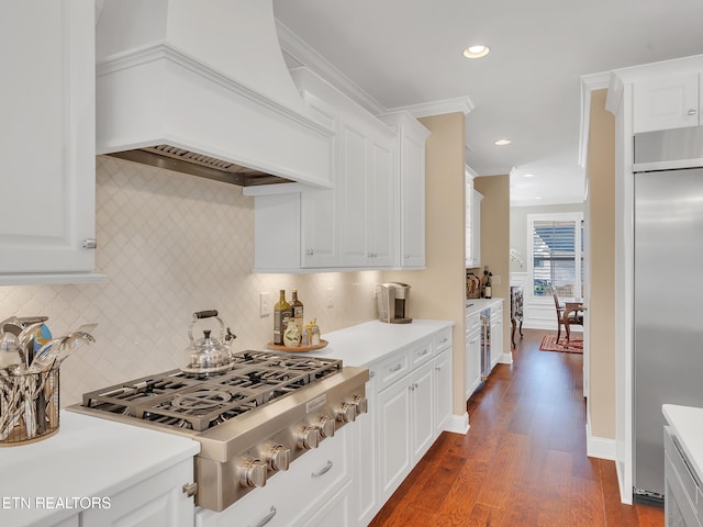 kitchen with light countertops, custom range hood, white cabinets, and stainless steel appliances