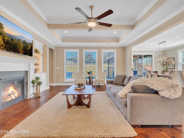 living area with a glass covered fireplace, dark wood-style floors, recessed lighting, crown molding, and baseboards