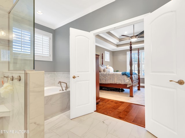 bathroom featuring a garden tub, ornamental molding, a stall shower, ensuite bathroom, and a ceiling fan