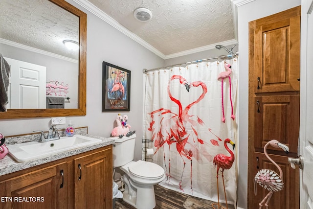 full bathroom with toilet, ornamental molding, vanity, a textured ceiling, and wood finished floors