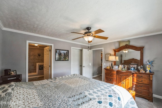 carpeted bedroom with crown molding, a textured ceiling, baseboards, and ensuite bathroom