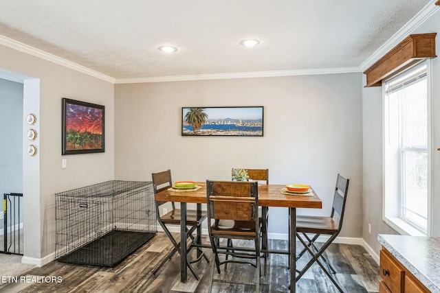 dining space with dark wood-style floors, baseboards, and crown molding